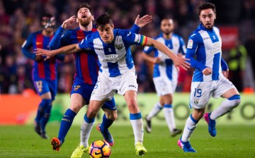 Leganes captain Martin Mantovani (#5) competes for the ball against Barcelona's Lionel Messi.