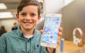  Levi aged 10, shows of the new iPhone 6s Plus in rose gold as crowds wait in anticipation for the release of the iPhone 6s and 6s Plus at Apple Store.