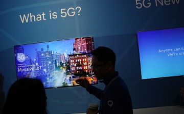 An attendee listens to information about 5G, aka 5th generation mobile networks, at the Qualcomm booth during CES 2017.