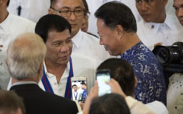 Philippine President Rodrigo Duterte (L) talks with Chinese Ambassador to the Philippines Zhao Jianhua.