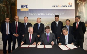 EDF Group CEO Jean-Bernard Levy, Britain's Business Minister Greg Clark, and China General Nuclear Corporation (CGN) Chairman He Yu, swap paperwork as they attend a signing ceremony in London.
