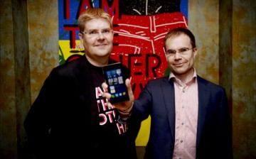 One of the founders of Jolla company, Sami Pienimaki, and company CEO Tomi Pienimaki (R) present the new Jolla smartphone that uses Linux-based Sailfish operating system.