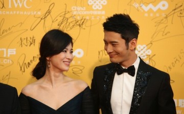 Korean actress Song Hye Kyo and Chinese actor Huang Xiaoming arrive for the red carpet of 4th Beijing International Film Festival at China's National Grand Theater on April 16, 2014 in Beijing, China. 