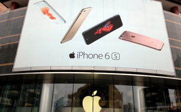 A billboard showing Apple phones is seen at an Apple Store in Beijing, China.
