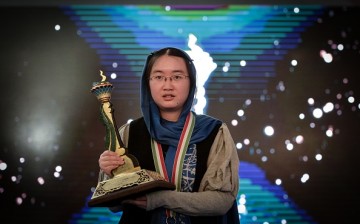 Chinese chess player Tan Zhongyi holds her trophy after she won the Women's World Chess Championship 2017.