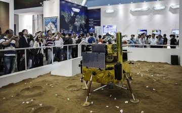 Visitors walk past a model of a Chinese lunar lander at the China International Aviation & Aerospace Exhibition in Zhuhai, China.