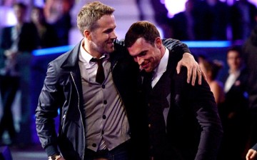 Ryan Reynolds and Ed Skrein accept the Best Fight award for 'Deadpool' onstage during the 2016 MTV Movie Awards at Warner Bros. Studios on April 9, 2016 in Burbank, California.
