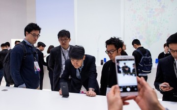 Visitors look at Oppo devices during the Mobile World Congress 2017
