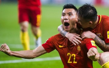 Chinese players celebrate after a major upset against South Korea in the World Cup Qualifiers.