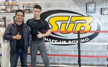 Filmmaker Conan Altatis poses with MMA fighter Mark Striegl in Shape-Up Boxing Gym in Baguio City, Philippines.