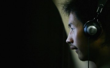 A young Chinese man in front of a computer