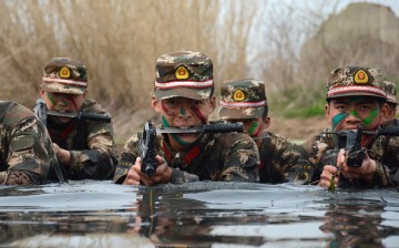 Armed Chinese commandos train in water on March 30, 2016 in Chuzhou, Anhui Province of China.