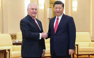 U.S. Secretary of State Rex Tillerson shakes hands with Chinese President Xi Jinping.
