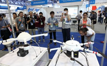  People crowd to view an exhibit on unmanned aerial vehicle models at the Aviation Expo China.