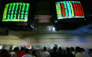 Investors view stock prices displayed on computers at a securities company, June 25, 2007, in Chongqing Municipality, China.