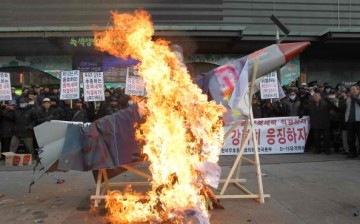 South Korean protesters burn an effigy of a North Korean missile.
