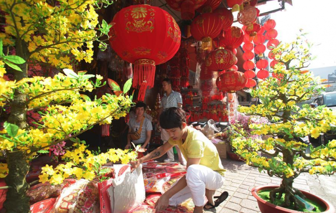 A seller prepares decorations for the Chinese New Year at a shop in Phnom Penh