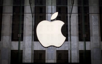 An Apple logo hangs above the entrance to the Apple store on 5th Avenue in the Manhattan borough of New York City, 