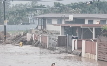 Floodwaters stream down a street in Hauula, Hawaii, U.S. March 9, 2021, in this still image obtained from a social media video.