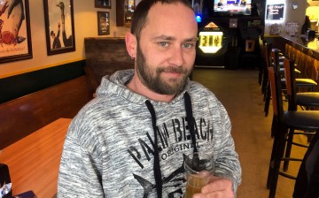 Aric Nowicki, who plans to use his stimulus check to pay overdue bills, is seen in a bar in Reedsburg, Wisconsin, U.S.