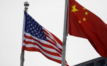 Chinese and U.S. flags flutter outside the building of an American company in Beijing, China 