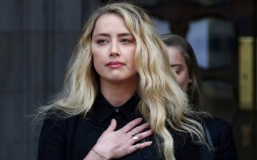 Actor Amber Heard delivers a statement as she leaves the High Court in London, Britain