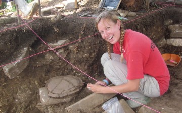 Archeologist Amy Thompson excavates at the ancient Maya site of Uxbenka, Belize in April 2012.