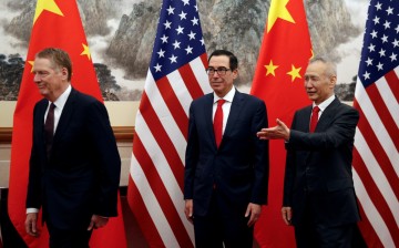 Chinese Vice Premier Liu He, right, shows the way to former U.S. Treasury Secretary Steven Mnuchin, center, and former U.S.