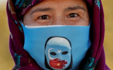 An Ethnic Uighur demonstrator wearing a protective face mask takes part in a protest against China, in Istanbul, Turkey