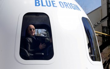 Amazon and Blue Origin founder Jeff Bezos addresses the media about the New Shepard rocket booster and Crew Capsule mockup at the 33rd Space Symposium