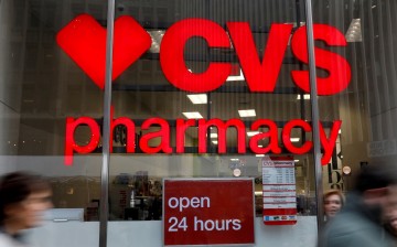 People walk by a CVS Pharmacy store in the Manhattan borough of New York City, New York,