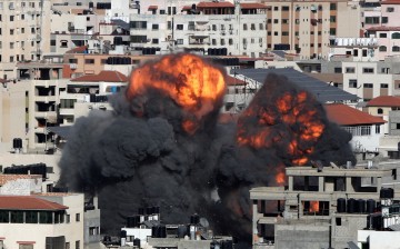 Smoke and flames rise during an Israeli air strike, amid a flare-up of Israeli-Palestinian violence, in Gaza City