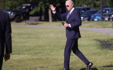 U.S. President Joe Biden waves before boarding the Marine One helicopter for a trip to the Coast Guard Academy from the Ellipse at the White House in Washington,