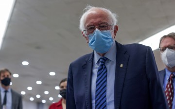 U.S. Senator Bernie Sanders (I-VT) talks to reporters as he transits the underground subway at the U.S. Capitol in Washington, U.S.