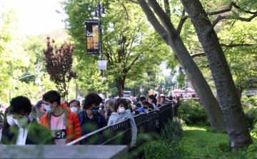 People ages 12 and older line up for COVID-19 vaccine appointments outside the American Museum of Natural History, in Manhattan, New York City,