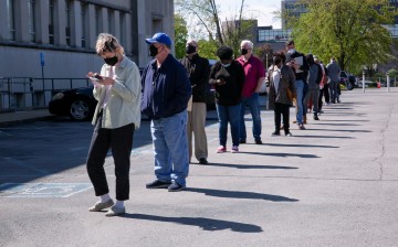 People line up outside a newly reopened career center for in-person appointments in Louisville, U.S.