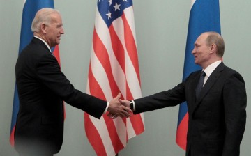 Russian Prime Minister Vladimir Putin (R) shakes hands with U.S. Vice President Joe Biden during their meeting in Moscow