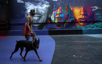  A man walks a dog as lockdown restrictions increase during the coronavirus disease (COVID-19) outbreak, in Santiago, Chile,