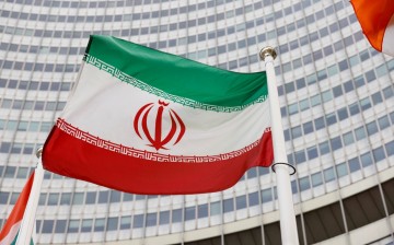 FILE PHOTO: The Iranian flag waves in front of the International Atomic Energy Agency (IAEA) headquarters,