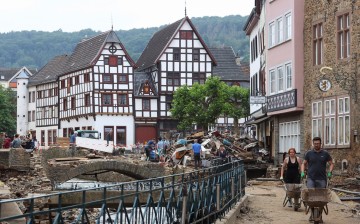 People work in an area affected by floods caused by heavy rainfalls in Bad Muenstereifel, Germany,