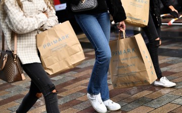 People carry Primark shopping bags after retail restrictions due to coronavirus disease (COVID-19) eased, in Belfast, Northern Ireland