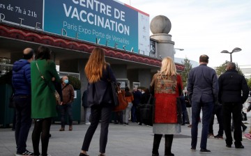 People queue outside a mass vaccination center in Paris, as part of the coronavirus disease (COVID-19) vaccination campaign in France, 