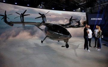 Brett Adcock (L) one of the co-founders and co-CEOs of flying taxi company Archer Aviation, talks with production people as they prepare the unveiling of their all-electric aircraft from a facility in Hawthorne, California, U.S