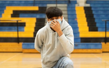 A sophomore student at Louise High School Antonio Martinez, 15, also a cross country runner, wears a mask as he poses, during the coronavirus disease (COVID-19) pandemic in Louise,