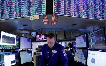 FILE PHOTO: A trader works on the trading floor at the New York Stock Exchange (NYSE) in Manhattan, New York City, U.S.,