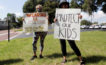 Supporters of wearing masks in schools protest before the special called school board workshop at the Pinellas County Schools Administration Building in Largo,