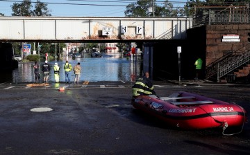 First responders stand by floodwaters to perform rescues of trapped local residents after the remnants of Tropical Storm Ida brought drenching rain, flash floods and tornadoes to parts of the northeast in Mamaroneck, New York,
