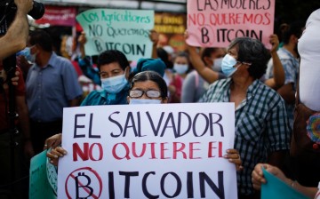 A person holds a sign that reads 'El Salvador doesn't want Bitcoin' as people participate in a protest against the use of Bitcoin as legal tender, in San Salvador, El Salvador,