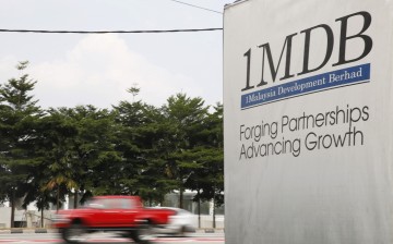 Traffic passes a 1Malaysia Development Berhad (1MDB) billboard at the Tun Razak Exchange development in Kuala Lumpur, Malaysia,