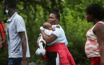 Migrants make preparations to cross into Panama and continue north, in Acandi, Colombia